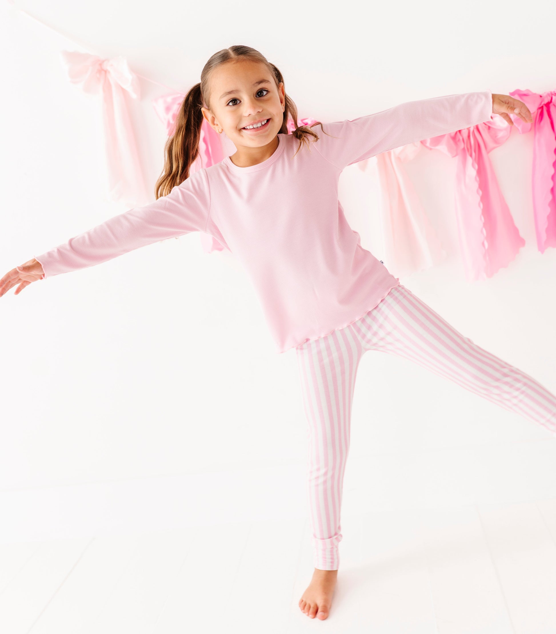 Pink ribbed leggings for girls paired with matching long sleeve top