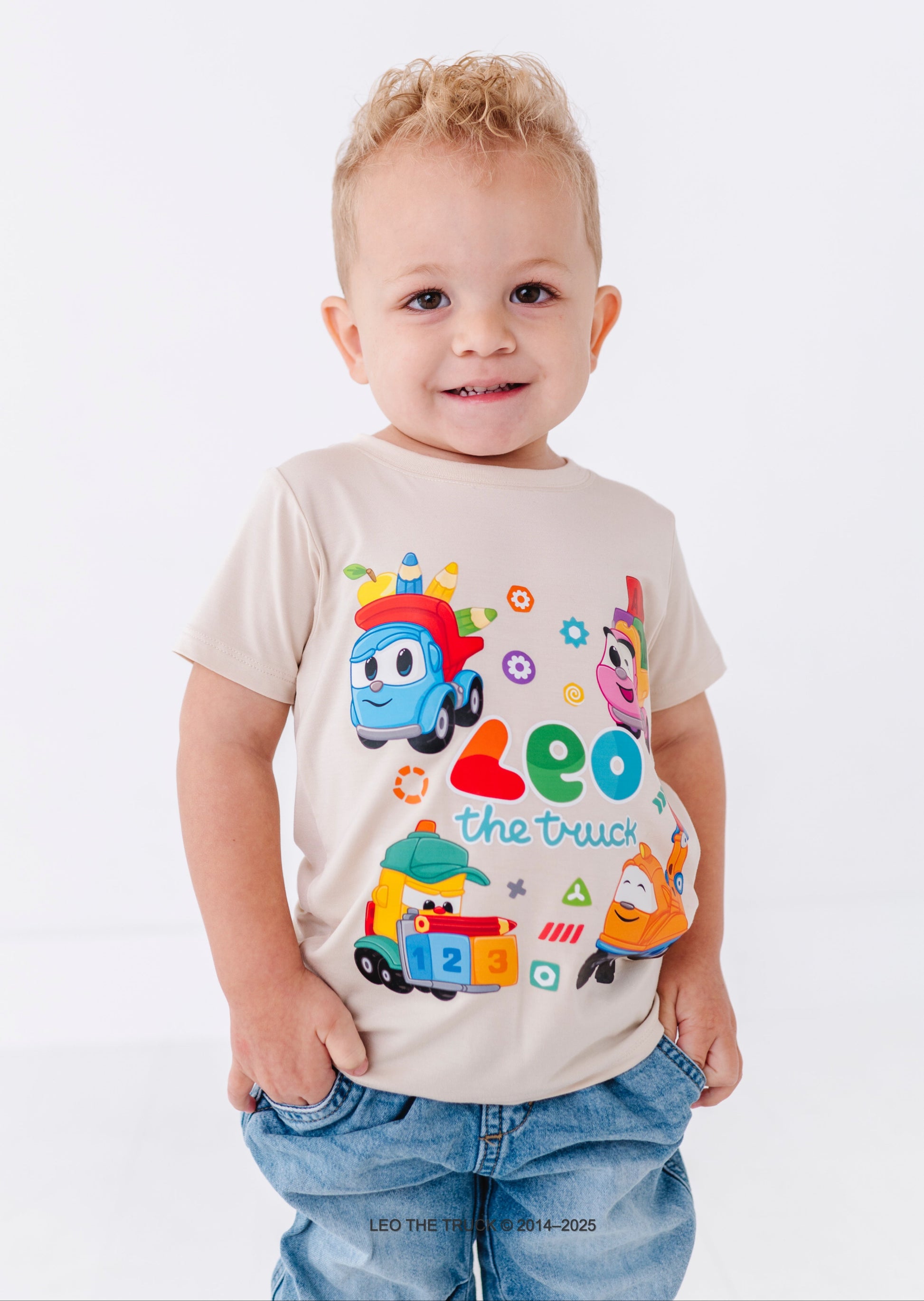 Toddler wearing a bamboo tee with colorful Leo the Truck graphics and text on a white background
