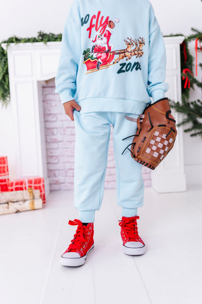 A close-up of light blue bamboo joggers with a baseball crewneck 
