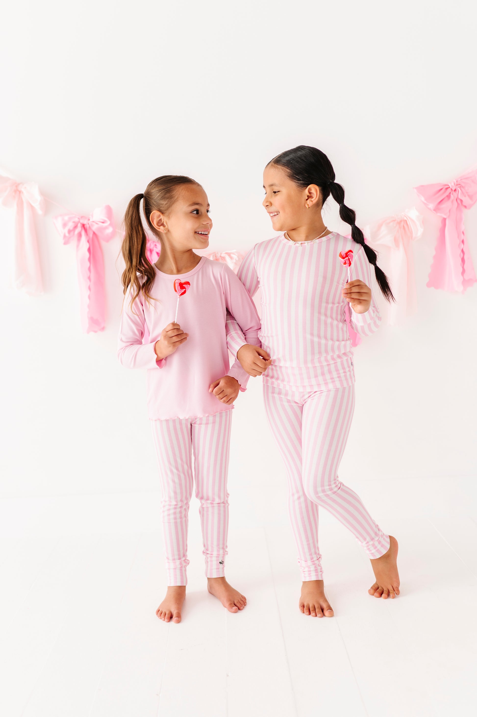 Child wearing pink stripe bamboo leggings with elastic waistband