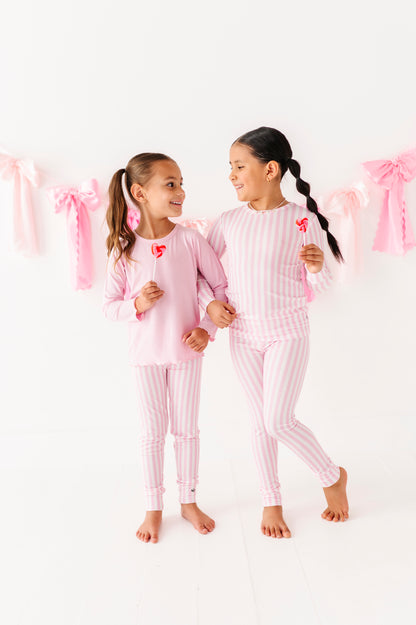 Child wearing pink stripe bamboo leggings with elastic waistband