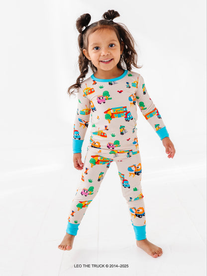 Toddler girl wearing bamboo Leo the Truck pajamas with on a white background