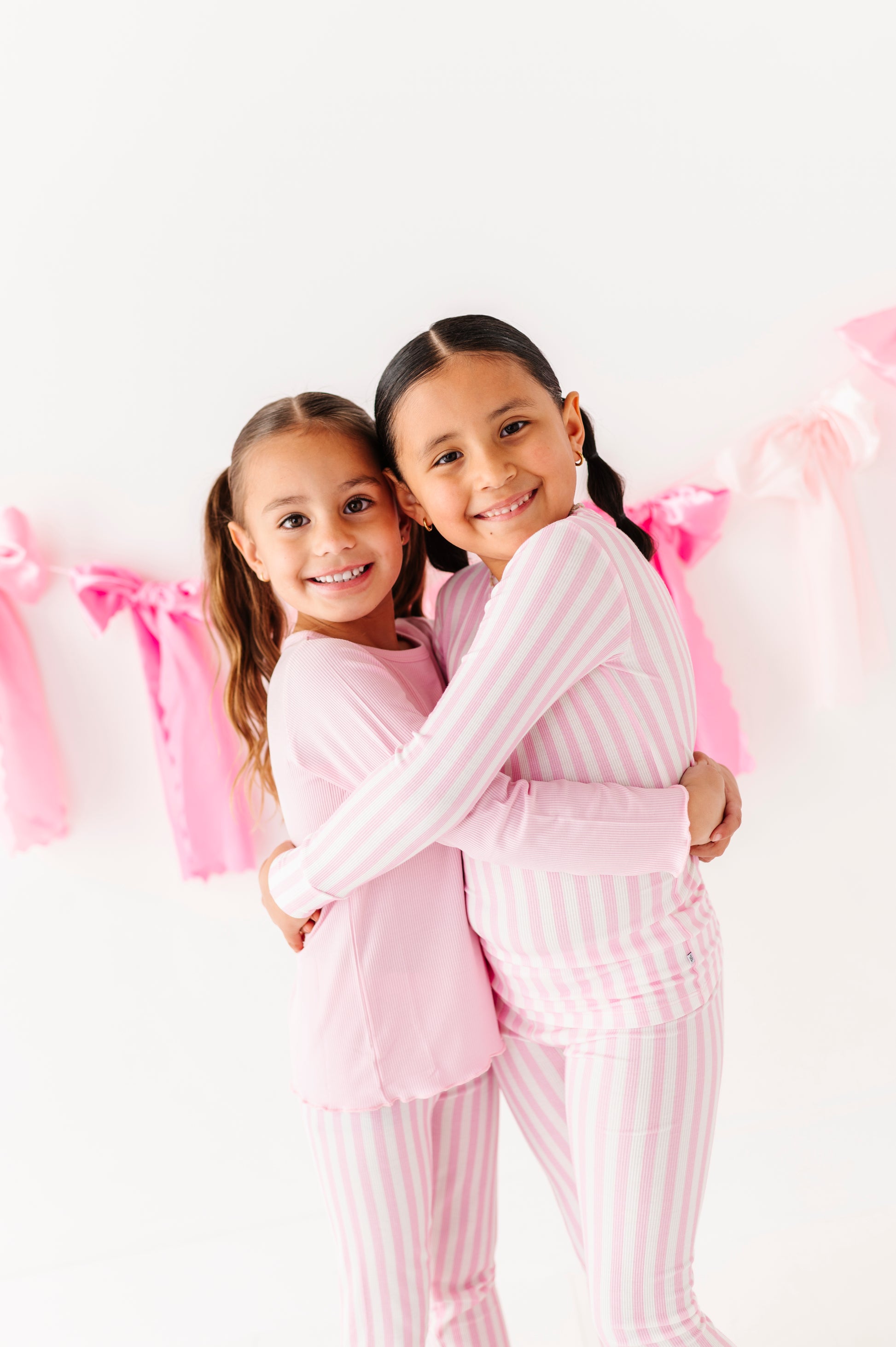 Pink ribbed lettuce hem top styled with striped leggings for girls