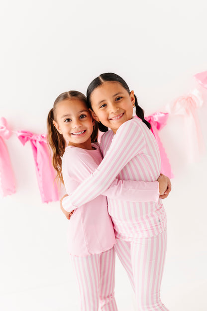 Pink ribbed lettuce hem top styled with striped leggings for girls