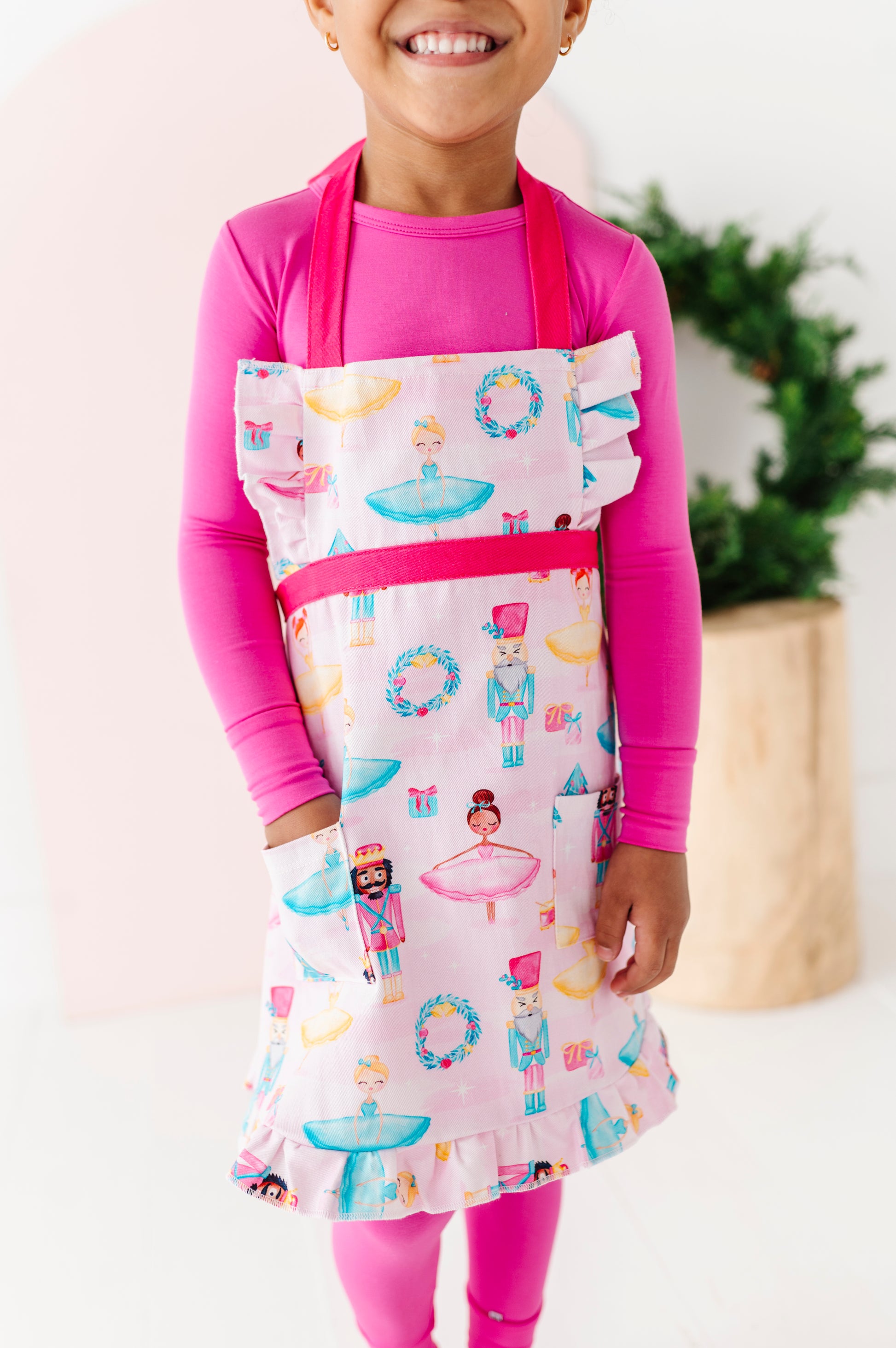 Child size Sugarplum apron with ruffle hem and front pocket detail