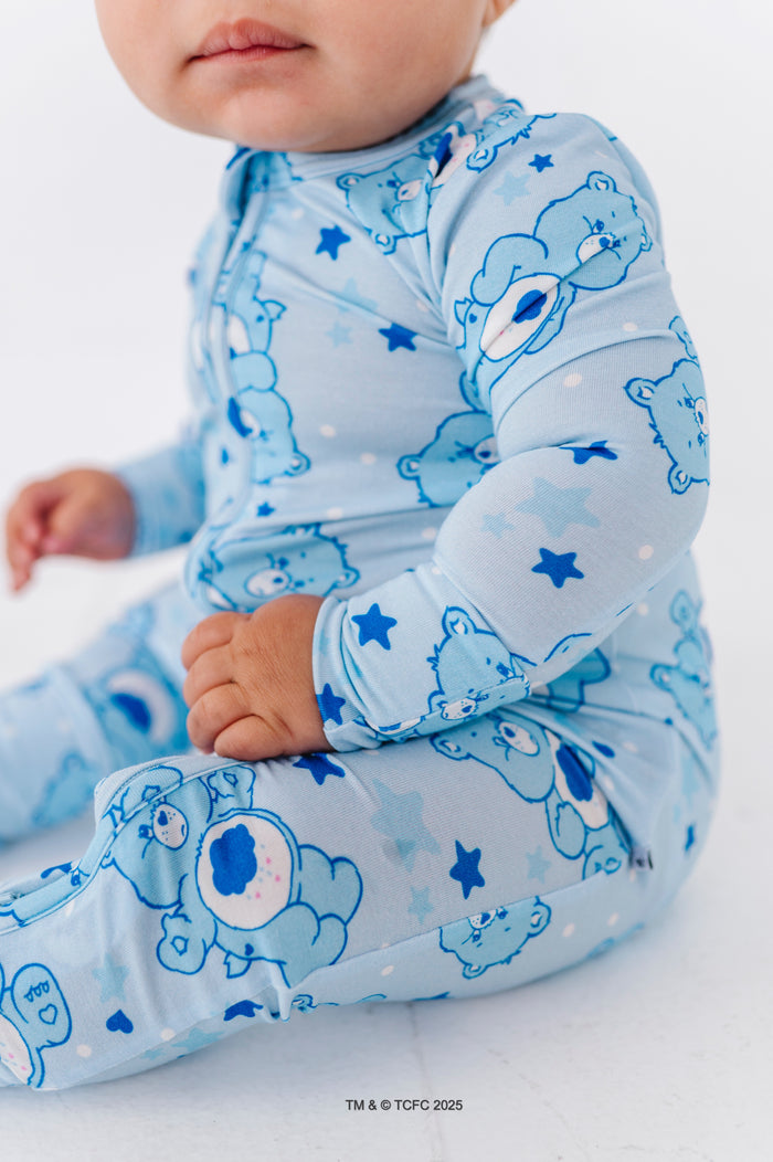 Close-up of Grumpy Bear print romper showing cloud belly badge and star details