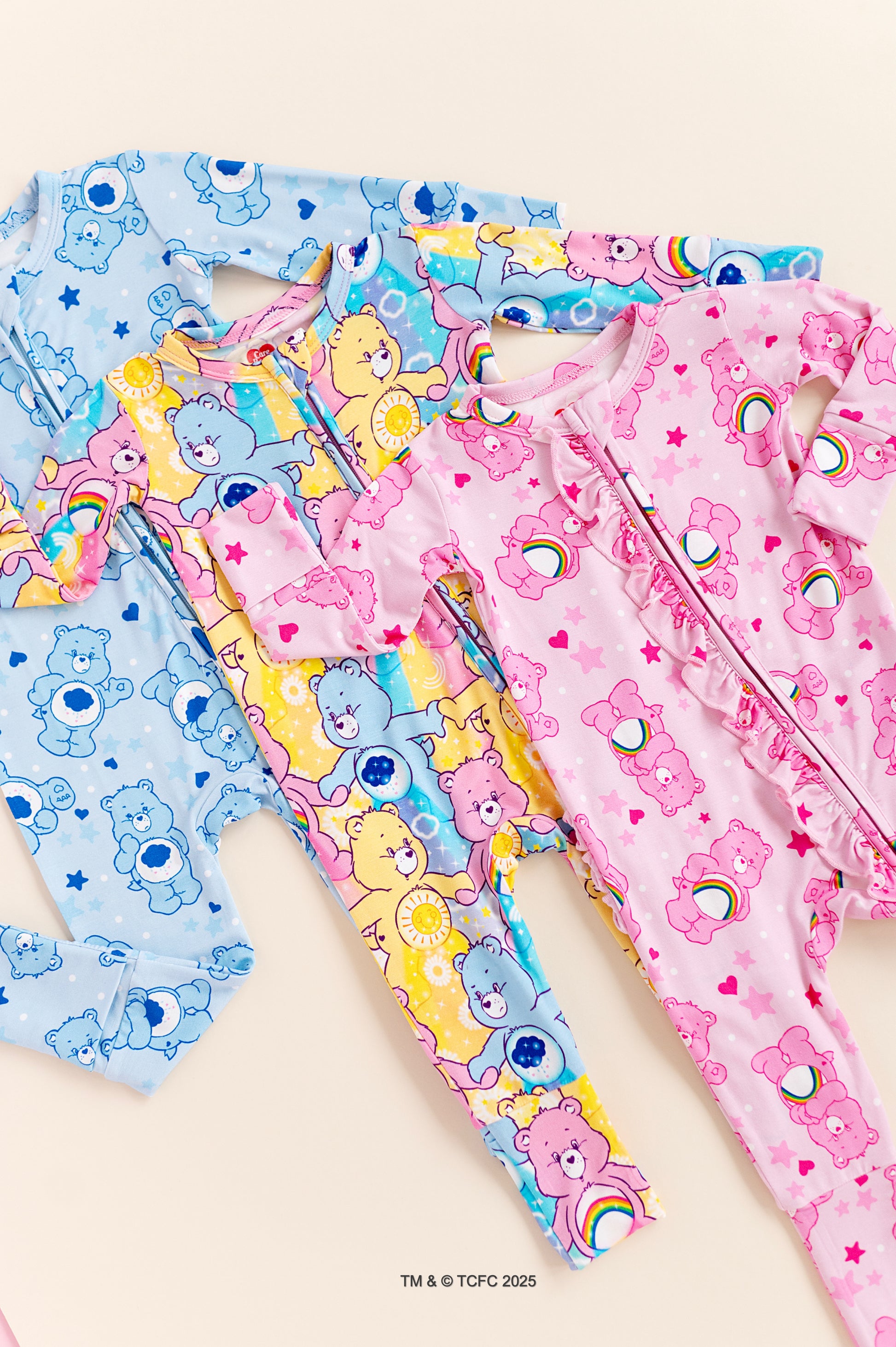 Set of colorful Care Bear-themed bamboo pajamas on a light background