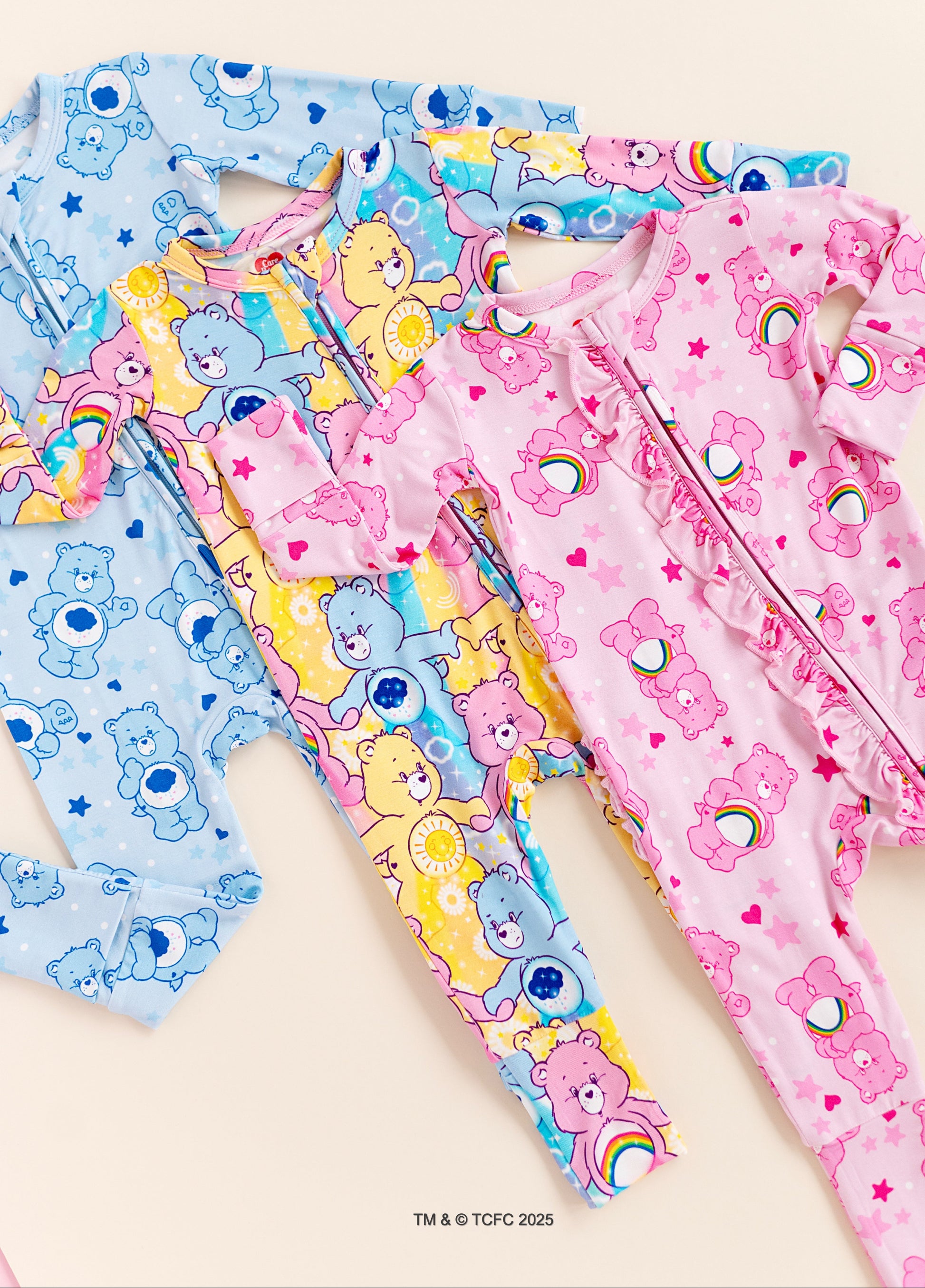 Flat lay of Care Bears™ Stare convertible bamboo romper with bold pastel colors and character print