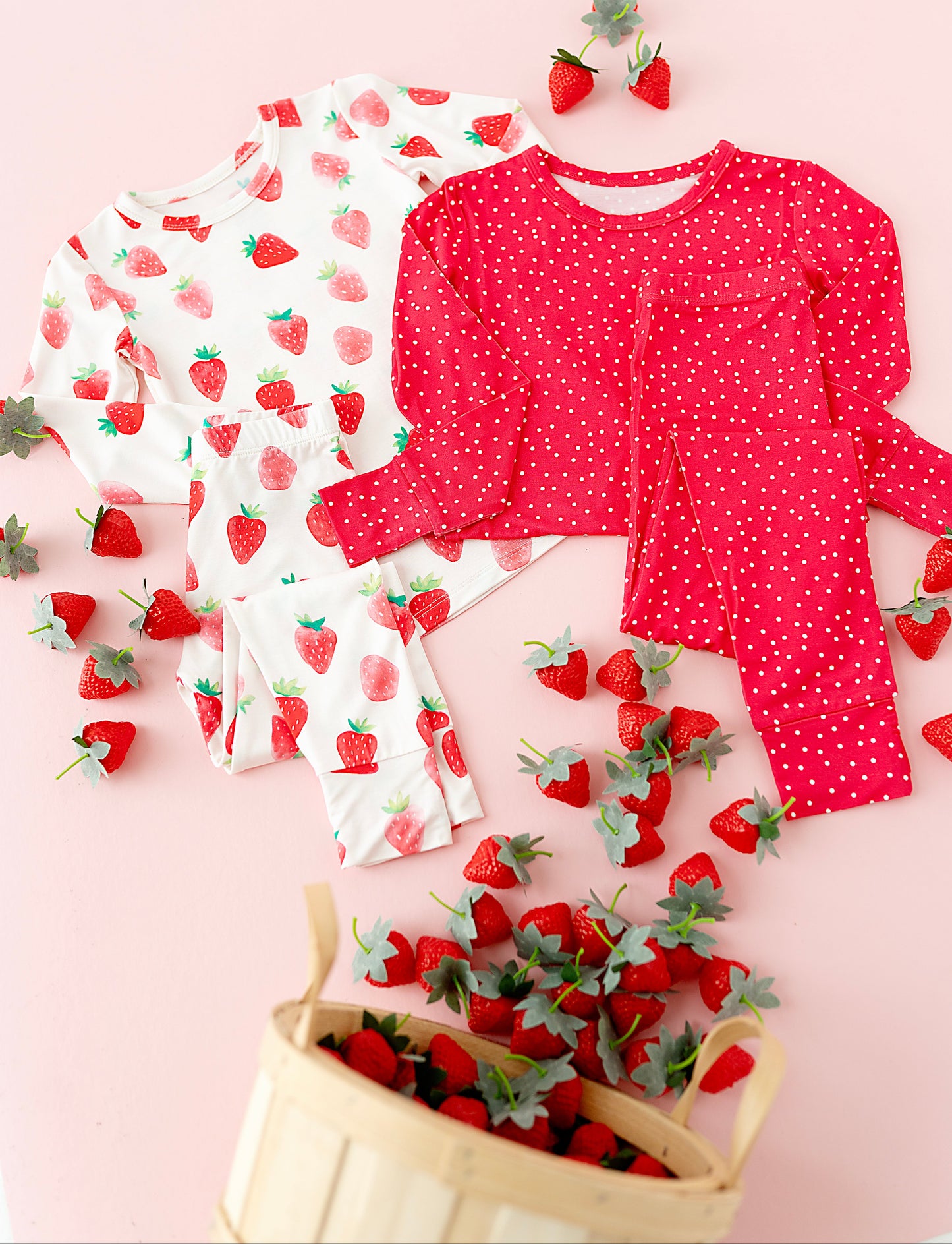 Children's strawberry-themed pajama sets with a pink background