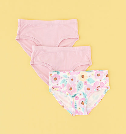 set of three underwear briefs for girls in two pink solids and a floral pattern on the third.