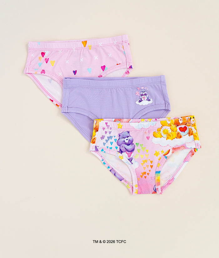 Three pairs of children's bamboo underwear with colorful Care Bears™ designs on a beige background