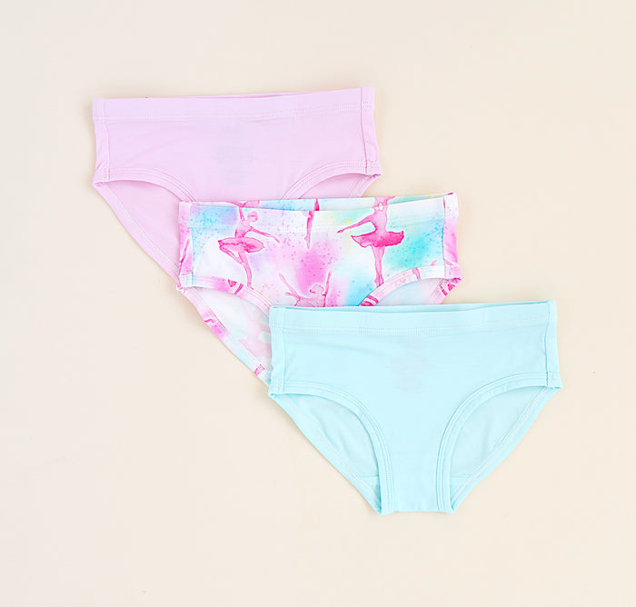 Three pairs of bamboo underwear with colorful designs on a beige background