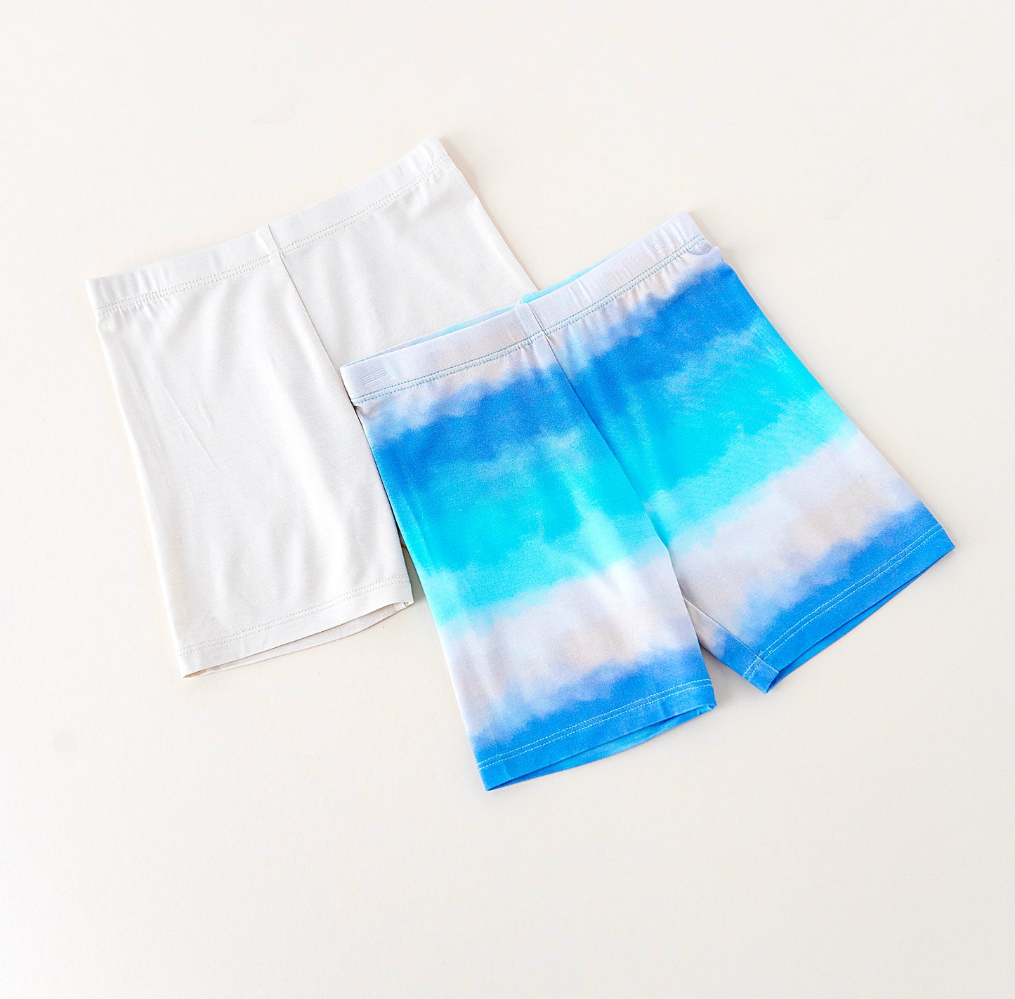 Pair of blue and white bamboo biker shorts on a light background