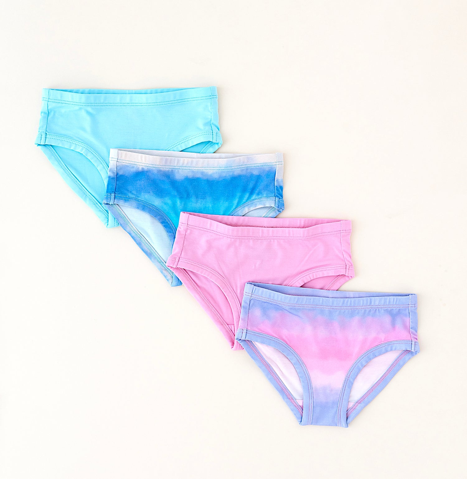 Set of four tie-dye bamboo underwear pieces on a white background