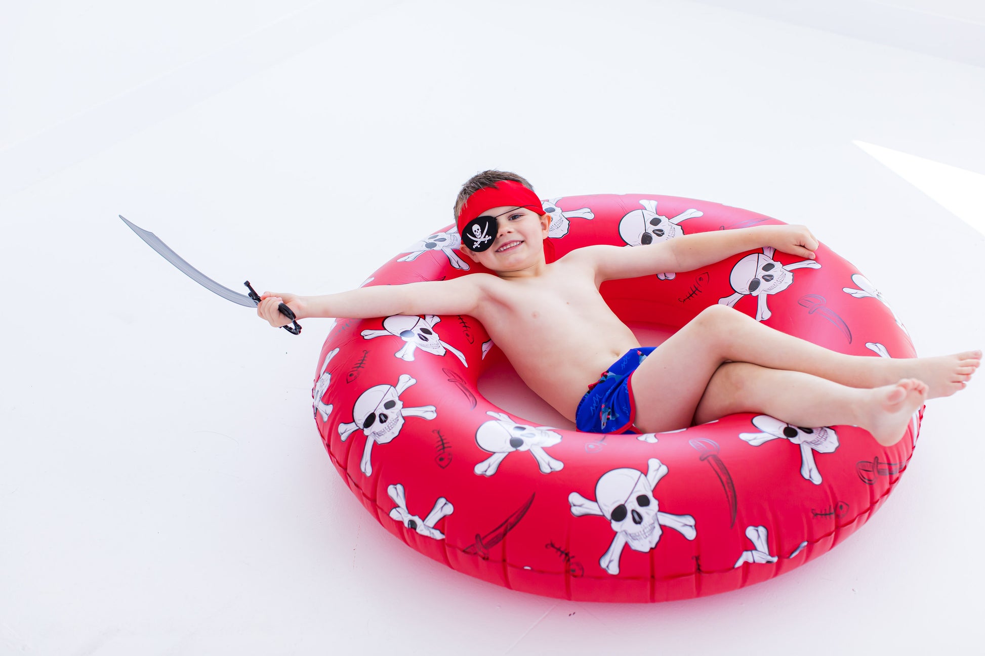Child wearing Sebastian Swim Shorties laying in a pirate float