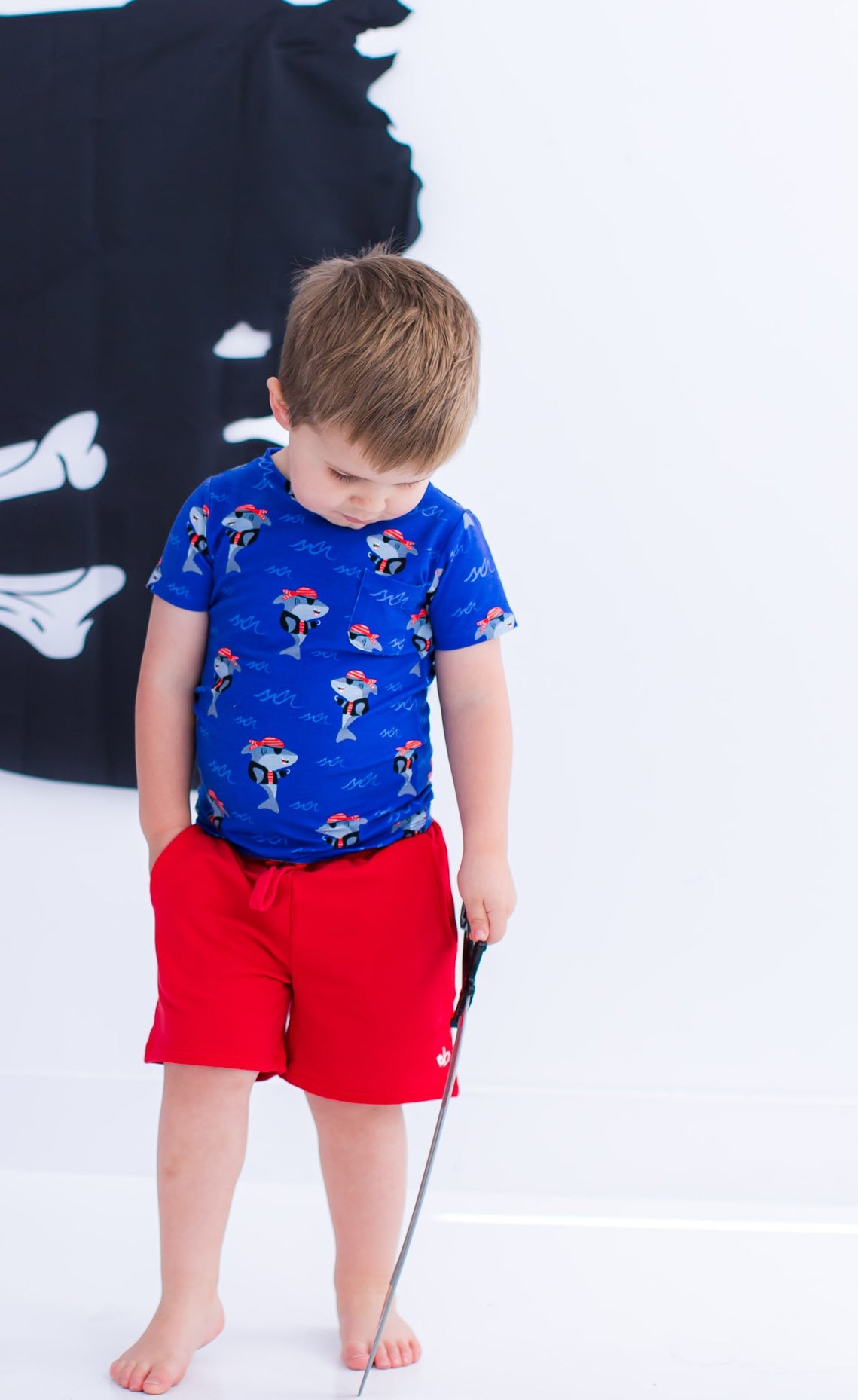 Toddler wearing Sebastian bamboo cotton pocket t-shirt with red shorts