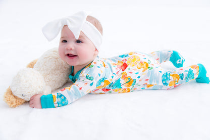 Baby wearing white headwrap bow styled with Birdie Bean bamboo apparel