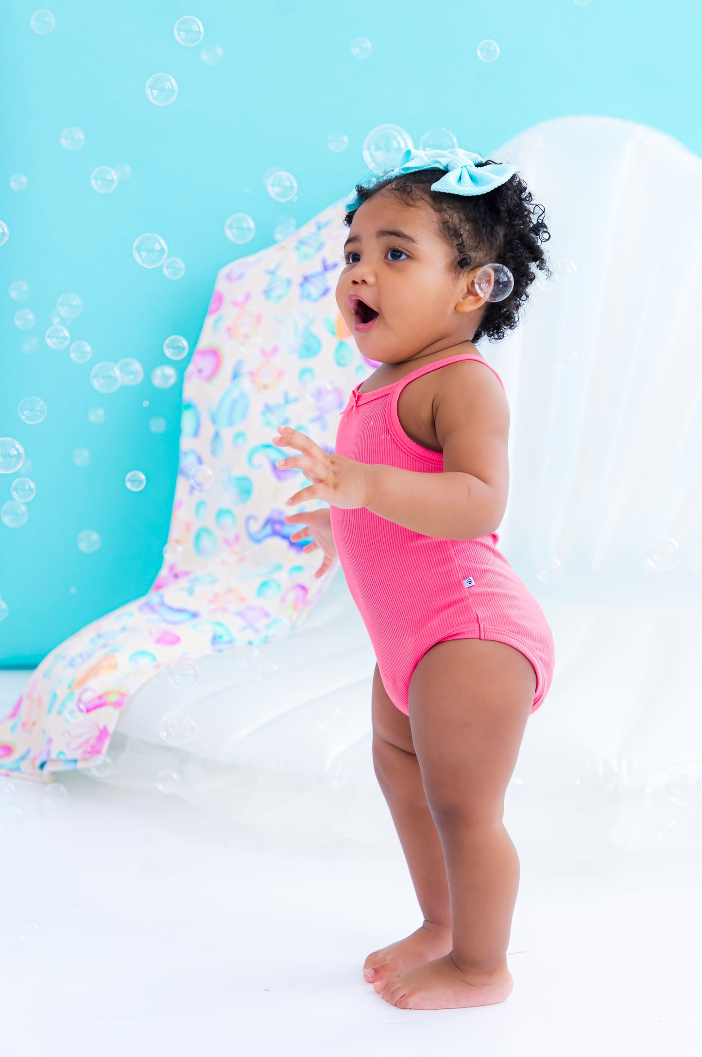 Baby wearing pink ribbed bamboo bodysuit tank