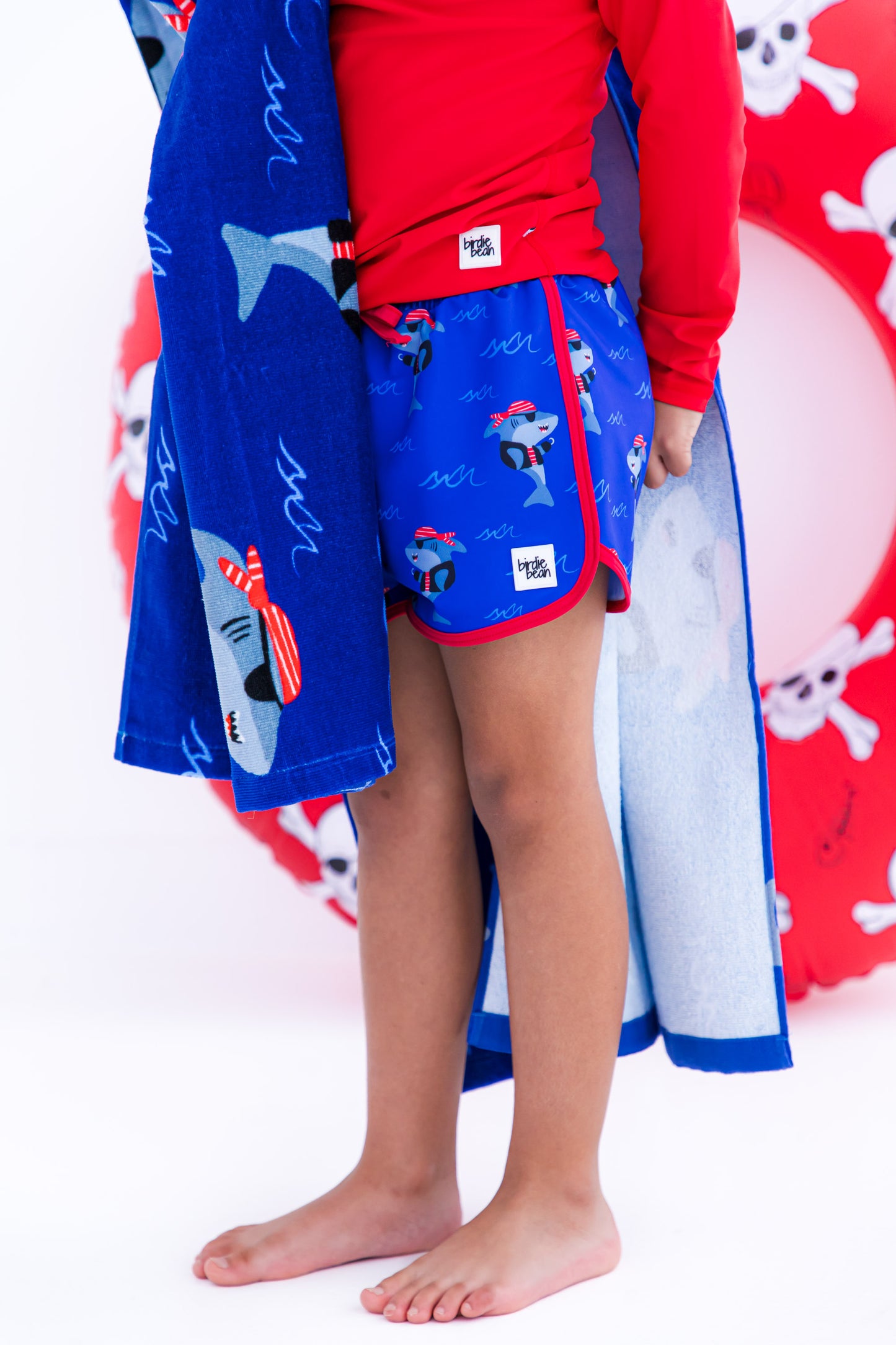 Sebastian Swim Shorties paired with crimson long-sleeve rash guard 