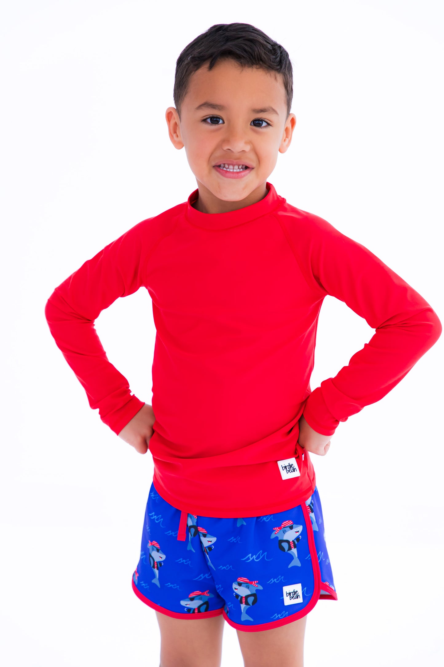 Sebastian Swim Shorties paired with crimson long-sleeve rash guard