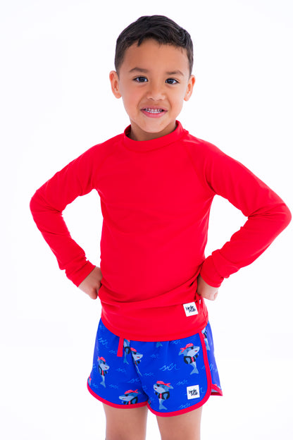 Sebastian Swim Shorties paired with crimson long-sleeve rash guard