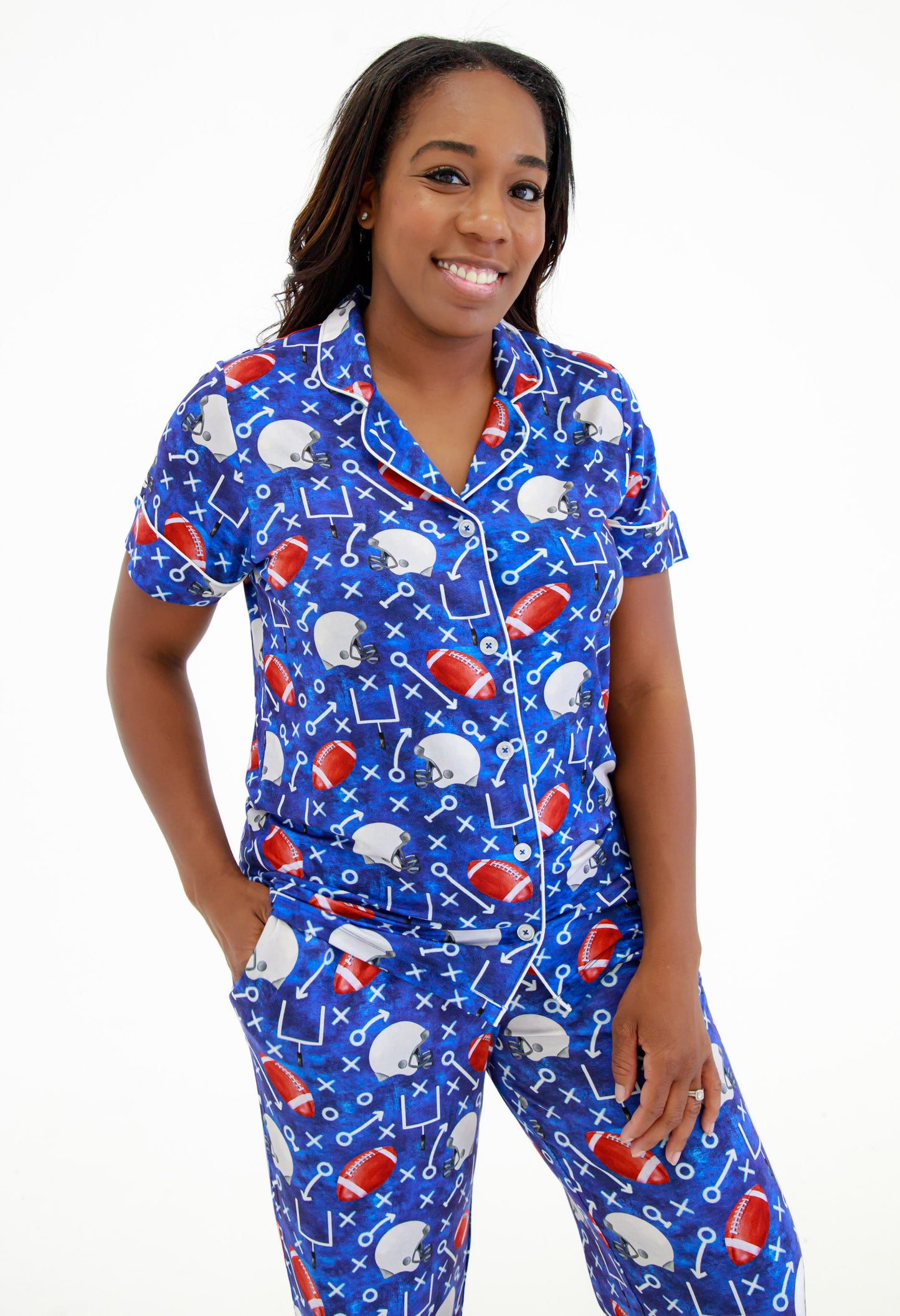 Woman wearing a blue bamboo pajama set with football-themed design on a white background