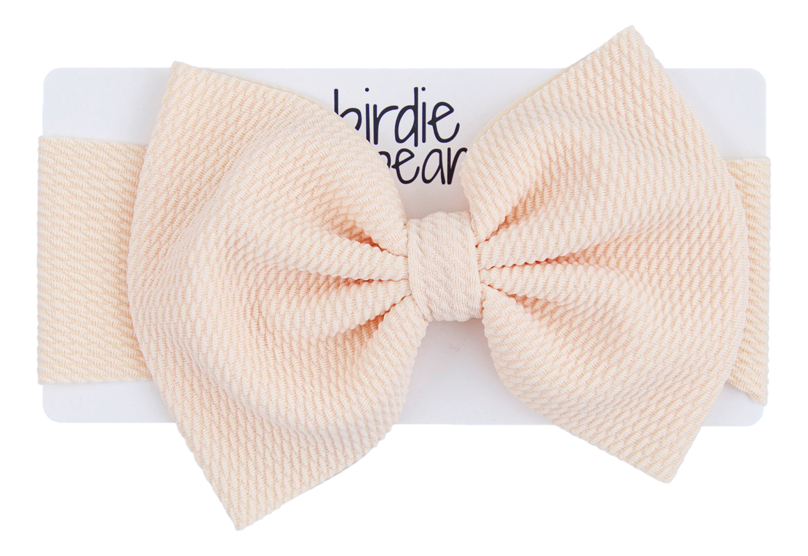 Large beige bow on a white background with 'birdie bear' branding.