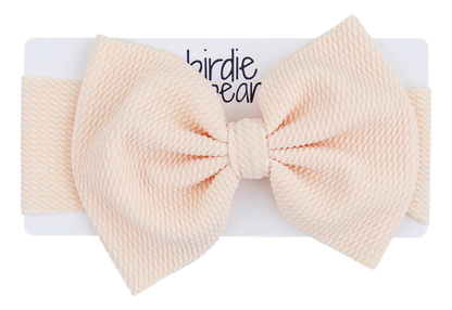 Large beige bow on a white background with 'birdie bear' branding.