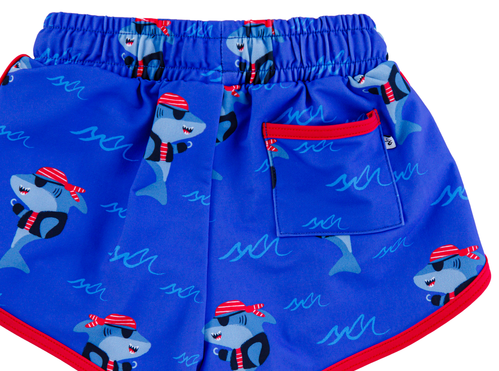 Sebastian Swim Shorties flat lay featuring functional back pocket, elastic waistband, and shark print