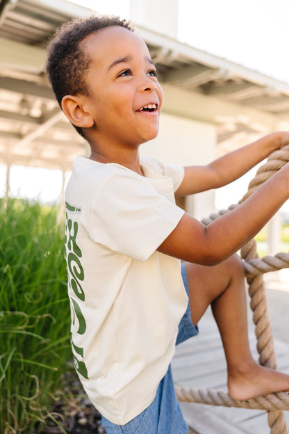 Child standing  on a rope with a natural background