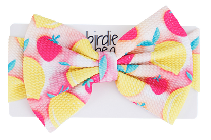 Colorful bow with lemons and strawberries on a white background