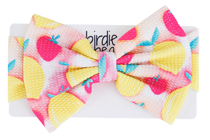 Colorful bow with lemons and strawberries on a white background