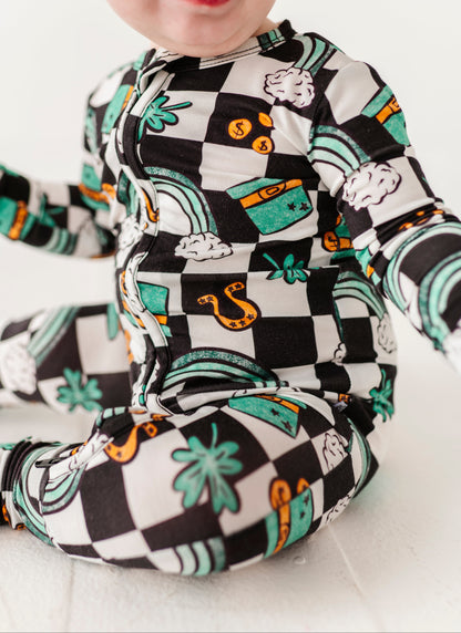 Close-up shot of a bamboo St. Patrick's Day themed convertible romper featuring top hats, four leaf colors, rainbows, and more!