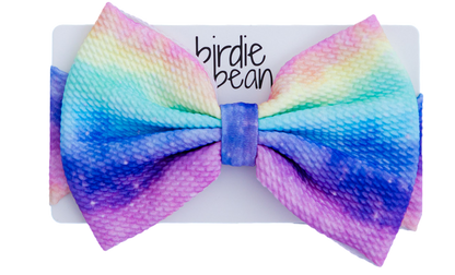 Colorful bow headband with gradient effect on a white background 