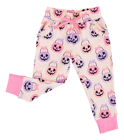 Children's Halloween-themed bamboo jogger pants with pumpkins and bows on a white background