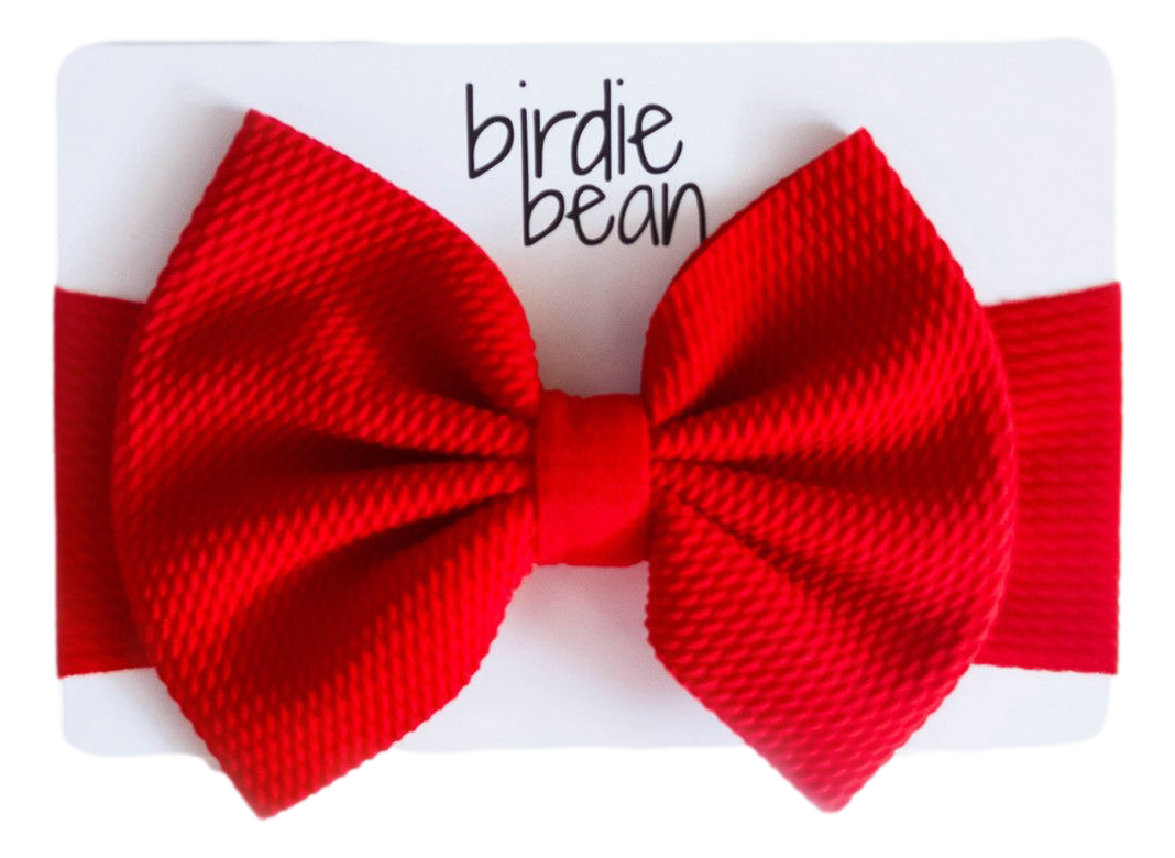 Red knitted bow on a white background with 'birdie bean' branding.